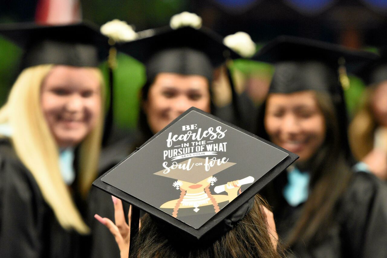 close up of graduation cap with inspiration saying, "Be fearless in the support of what sets your soul on fire"