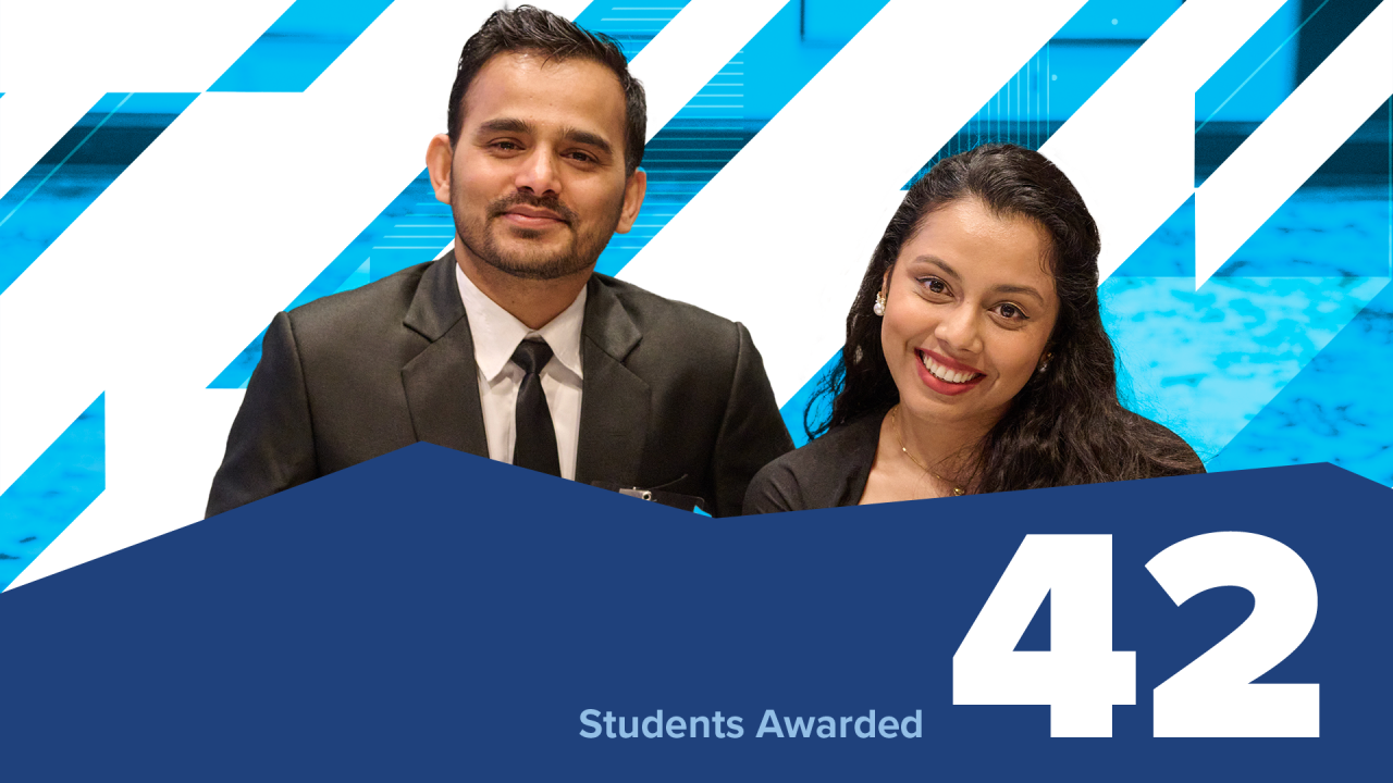 two students smile at camera. embedded text: 42 students awarded