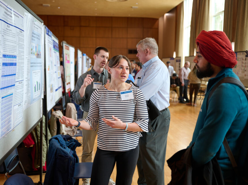 student presents research poster at exhibition